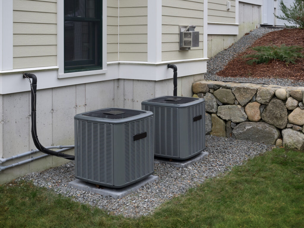 Two new heat pumps installed outside of a New York home.