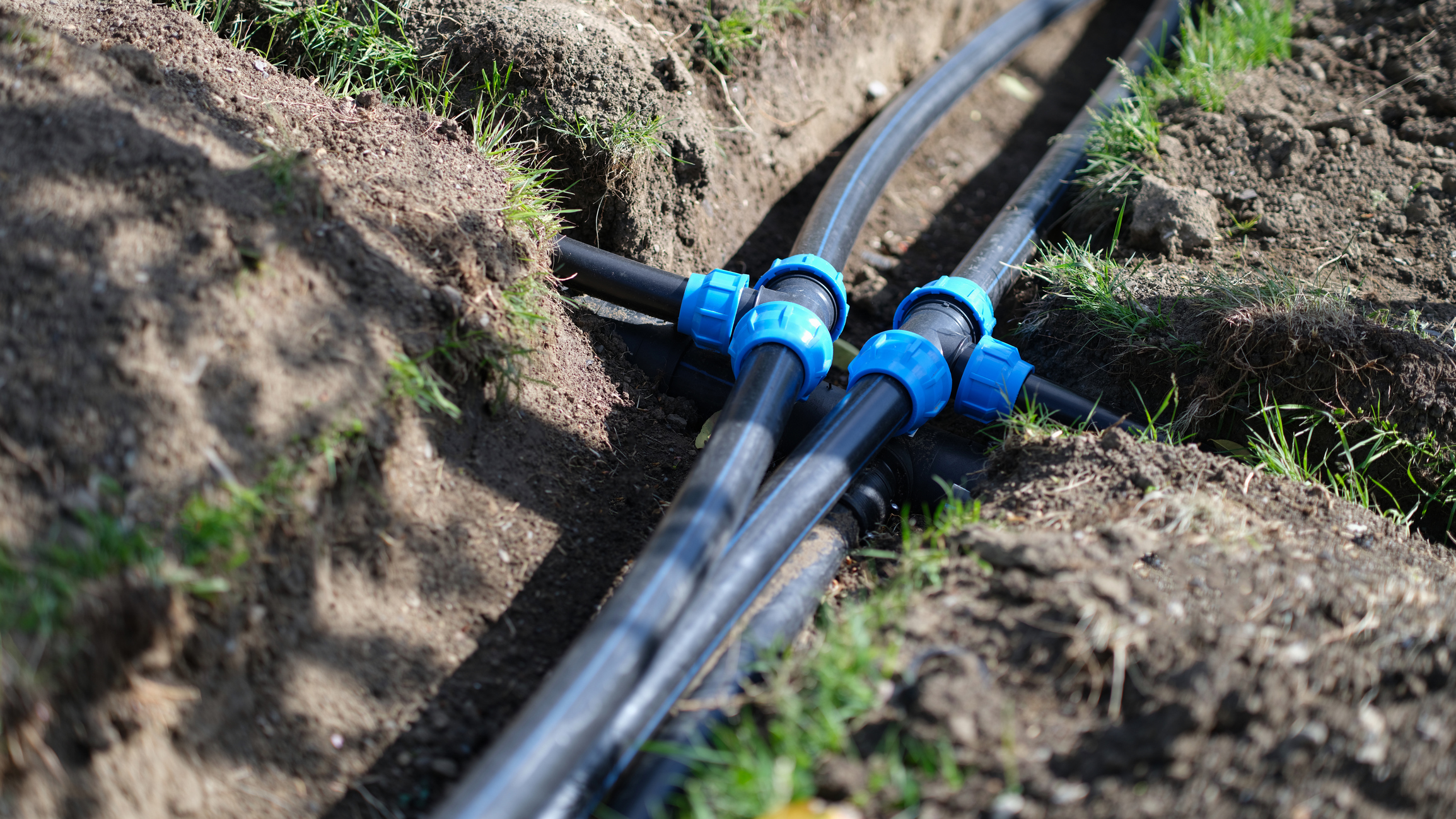 Water lines outside of a home in the yard.